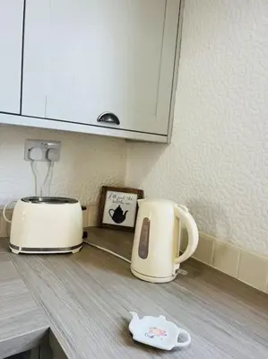 a toaster and coffee maker on a kitchen counter at Willow Cottage - Billinge Wigan, sleeps 4 , parking and garden in Billinge