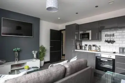 a living room with a couch and a kitchen at *Liverpool City Centre Modern Stylish Apartment in Liverpool