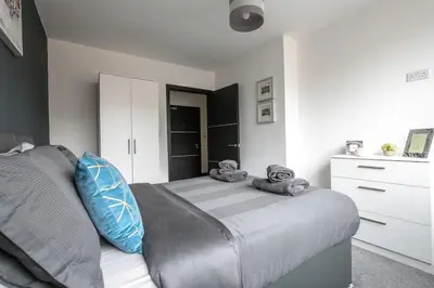 a bedroom with a bed with towels on it at *Liverpool City Centre Modern Stylish Apartment in Liverpool