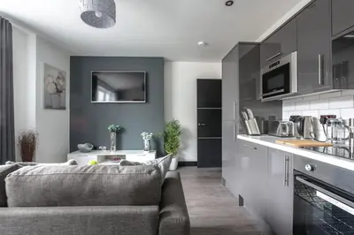 a living room with a couch and a kitchen at *Liverpool City Centre Modern Stylish Apartment in Liverpool