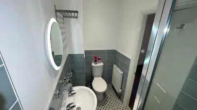 a bathroom with a toilet and a sink and a mirror at ANFIELD PLACE TO STAY in Liverpool