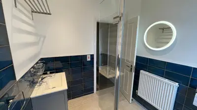 a bathroom with a shower and a sink and a mirror at ANFIELD PLACE TO STAY in Liverpool
