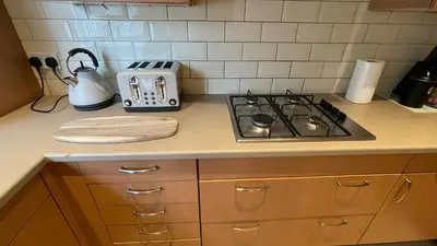 a kitchen counter with a stove and a toaster at ANFIELD PLACE TO STAY in Liverpool