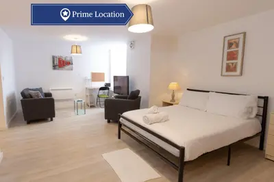 a bedroom with a bed and a living room at Cosy Studio Apt in Preston near City Centre in Preston