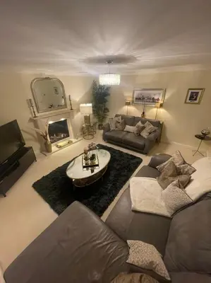 a living room with a couch and a fireplace at Home in Wirral - Peaceful Contemporary Gem. in Wirral
