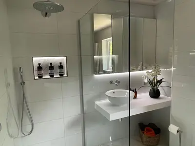 a white bathroom with a sink and a shower at Home in Wirral - Peaceful Contemporary Gem. in Wirral