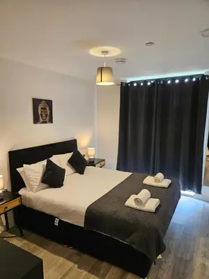 a bedroom with a bed with two towels on it at Liverpool modern family living in Liverpool