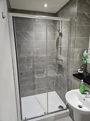 a bathroom with a shower and a sink at Liverpool modern family living in Liverpool