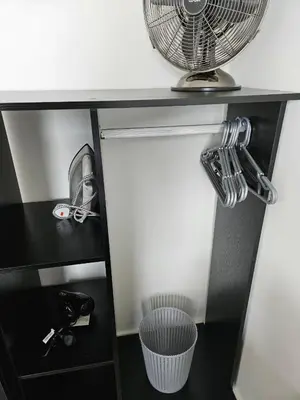 a black shelf with a fan and a basket at Liverpool modern family living in Liverpool