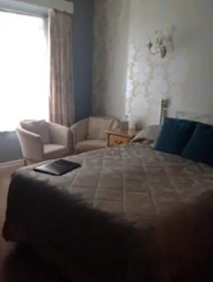 a bedroom with a large bed and a window at Yacht Bay View in Morecambe