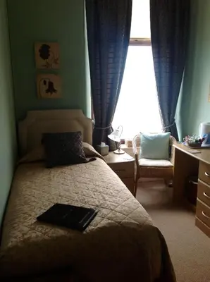 a bedroom with a bed with a laptop on it at Yacht Bay View in Morecambe