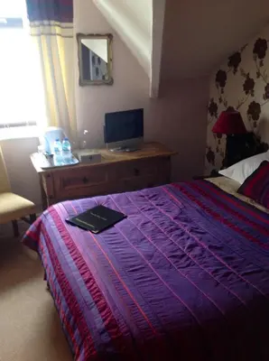 a bedroom with a bed and a desk with a computer at Yacht Bay View in Morecambe