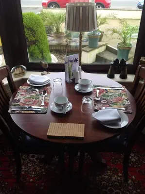 a wooden table with plates and dishes on it at Yacht Bay View in Morecambe