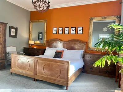 a bedroom with a large bed with an orange wall at Winter Escape with heated pool in Roby