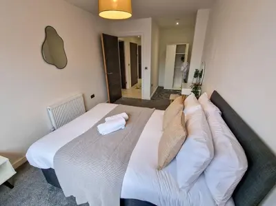 a bedroom with a large white bed with pillows at Liverpool Baltic Flat in Liverpool
