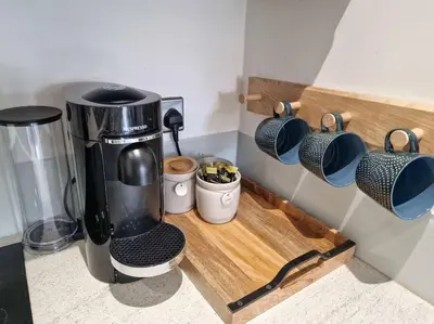 a coffee maker on a counter with coffee cups at Liverpool Baltic Flat in Liverpool