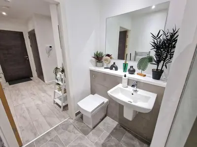 a bathroom with a sink and a toilet and a mirror at Liverpool Baltic Flat in Liverpool