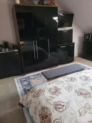 a living room with a fireplace and a rug at Morecambe Seaside Room in Heysham