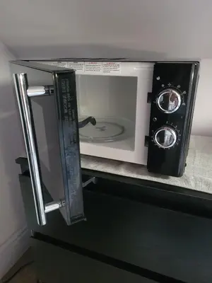 a microwave oven with its door open on a counter at Morecambe Seaside Room in Heysham