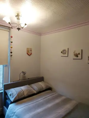 a bedroom with a bed in the corner of a room at Morecambe Seaside Room in Heysham