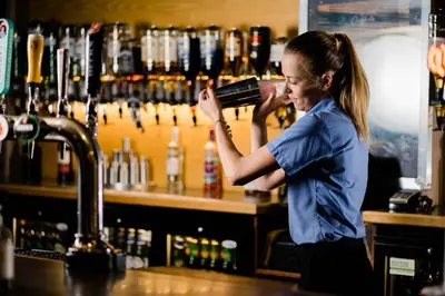 a woman standing at a bar drinking from at Viking Hotel - Adults Only in Blackpool