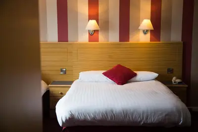 a hotel room with a bed with a red pillow at Viking Hotel - Adults Only in Blackpool