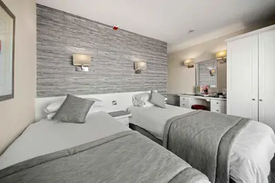 a hotel room with two beds and a kitchen at Viking Hotel - Adults Only in Blackpool
