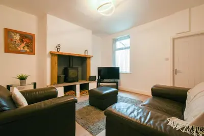 a living room with a couch and a television at Home in the Heart of Accrington in Church