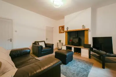 a living room with a couch and a television at Home in the Heart of Accrington in Church