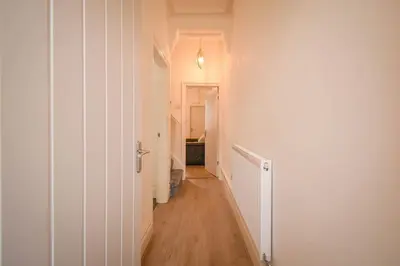 a hallway with white walls and wooden floors and a room at Home in the Heart of Accrington in Church
