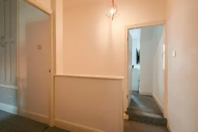 a hallway with a door leading into a room with a hallway at Home in the Heart of Accrington in Church