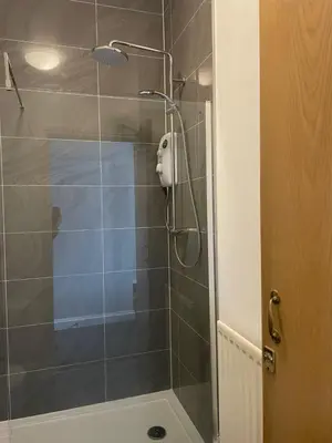 a shower with a glass door in a bathroom at Feildens Arms Hotel in Blackburn