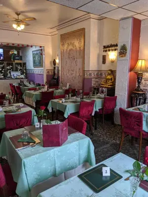a dining room with tables and red chairs at The New Guilderoy Hotel in Blackpool