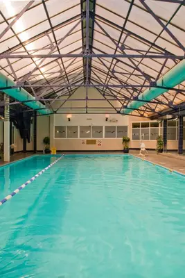 a large swimming pool with a large ceiling at Norbreck Castle Hotel in Blackpool