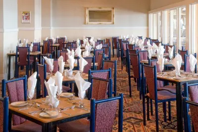 a row of tables and chairs in a room at Norbreck Castle Hotel in Blackpool