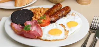 a plate of breakfast food with eggs beans and bacon at Norbreck Castle Hotel in Blackpool