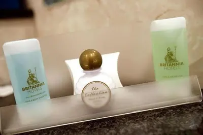 a tray with two candles and a bottle of perfume at Norbreck Castle Hotel in Blackpool