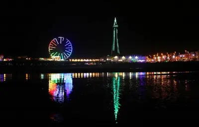 a night view of a ferris wheel and a city at Norbreck Castle Hotel in Blackpool