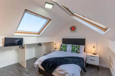 a bedroom with a bed and a window at 2 The Cottage in Upholland
