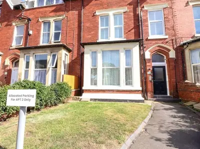 a sign in front of a brick house at The Hideaway - Perfect couples retreat with Free parking on driveway in Lytham St Annes