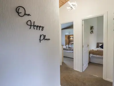 a bedroom with a sign that says harper plan on the wall at Our Happy Place in Carnforth