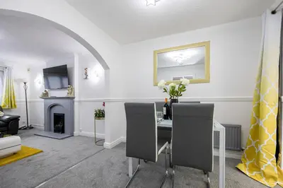 a dining room with a table with chairs and a fireplace at E&E's House in Cherry Tree