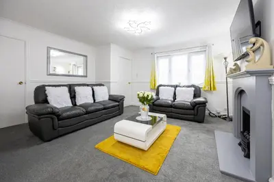 a living room with black furniture and a fireplace at E&E's House in Cherry Tree