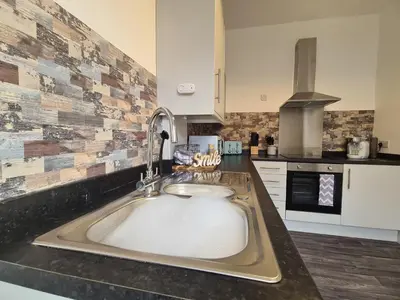 a kitchen with a large sink in a counter at Tower Views 2 Bedroom House with Private Parking in Blackpool