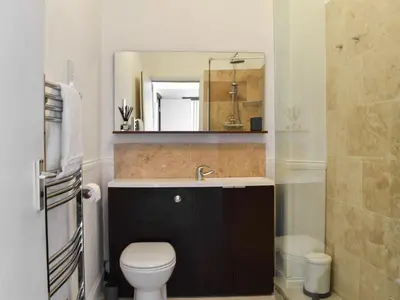 a bathroom with a sink and a toilet and a mirror at Blue Sands in Morecambe