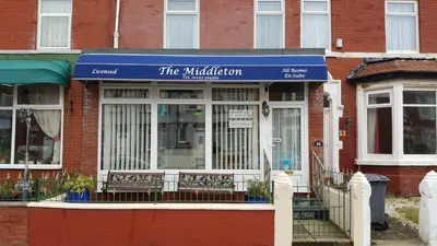 a store with a blue sign in front of a building at The Middleton in Blackpool