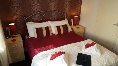 a bedroom with a bed with a laptop on it at The Middleton in Blackpool