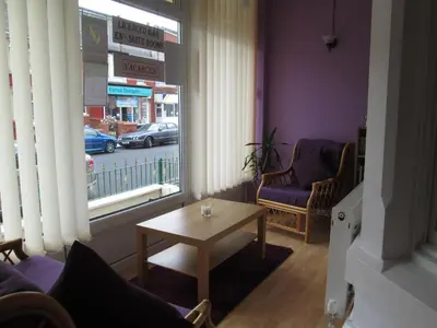 a living room with a table and a window at The Middleton in Blackpool