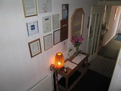 a hallway with a table and a lamp on a wall at The Middleton in Blackpool