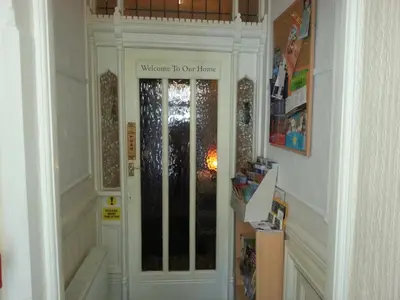 a hallway with a door with a welcome to our home sign at The Middleton in Blackpool